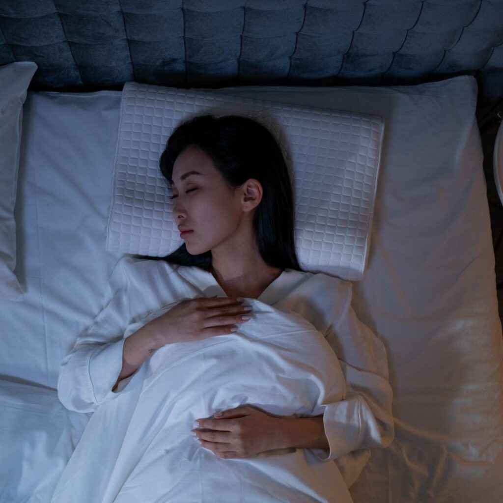 Woman Sleeping on a Bed