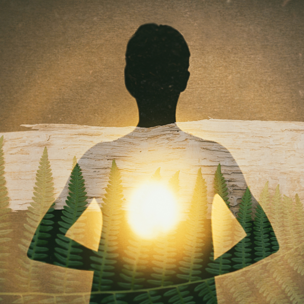 Female silhouette radiating light from within a spiritual heart opening