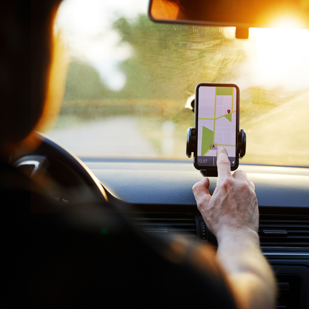 Driver Uses Navigation on His Mobile Phone in the Car