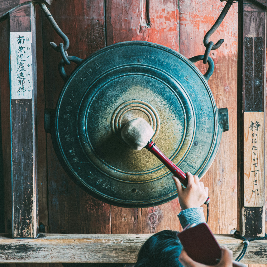person holding round brown metal tool