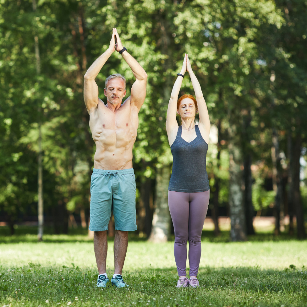 Sporty couple doing breath exercise