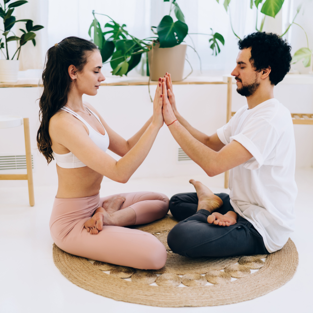 Sporty couple doing breath exercise