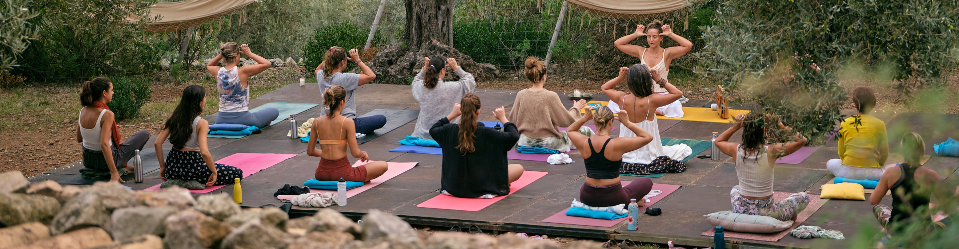 Women practicing yoga in countryside