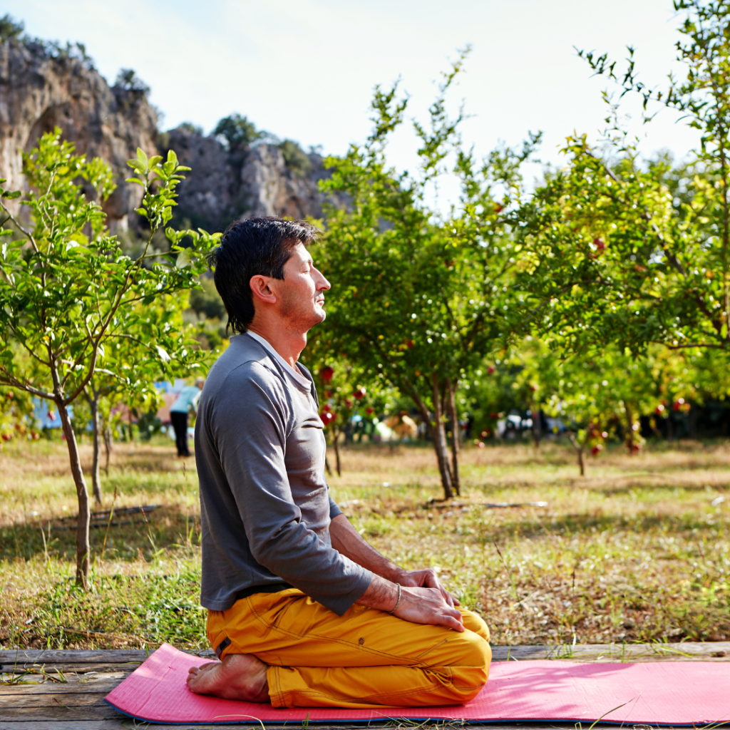 Man meditates in garden