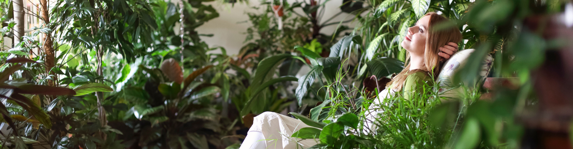 Relaxed Woman in Room with Green Plants