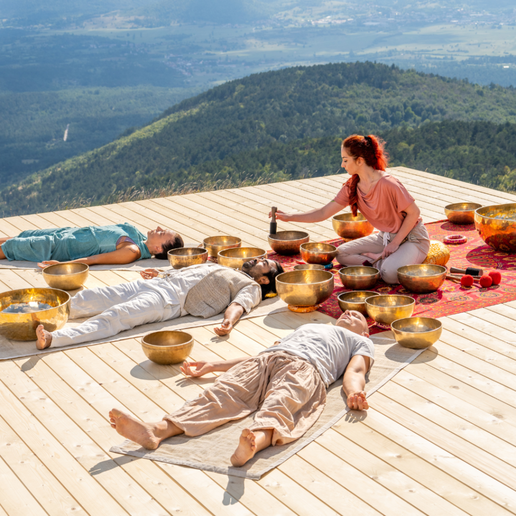 Singing bowls meditation, people group at sound healing therapy session