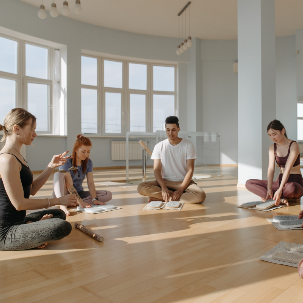 Group of People Sitting on Brown Wooden Floor