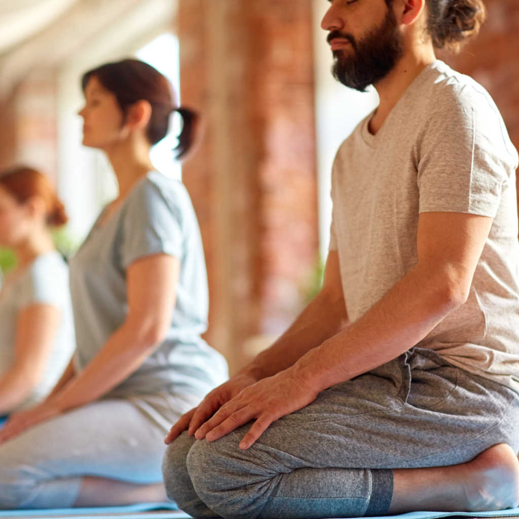 Group of People Doing Yoga Kneeling Pose at Studio