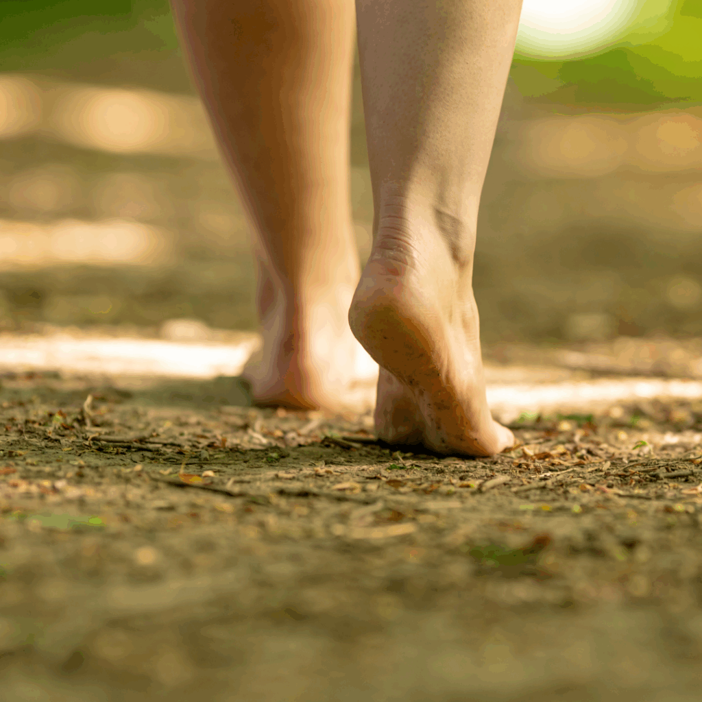 Walking Bare Feet Along a Trail in the Woods