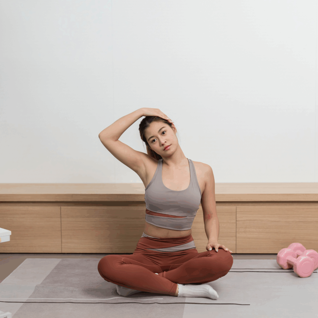 Yoga session at home. Woman performing neck stretch on exercise