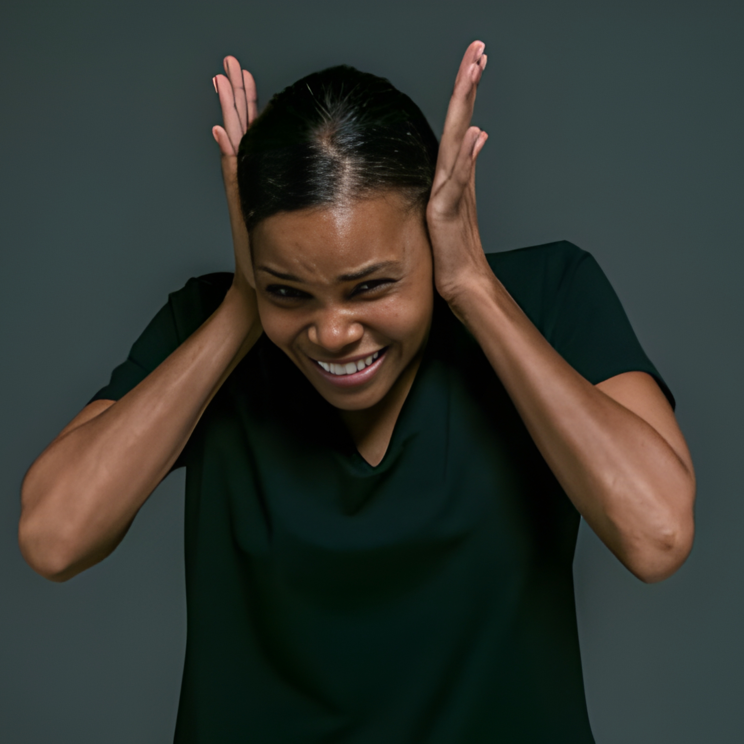 Woman holding her head and covering her ears, expressing mental overload and emotional stress